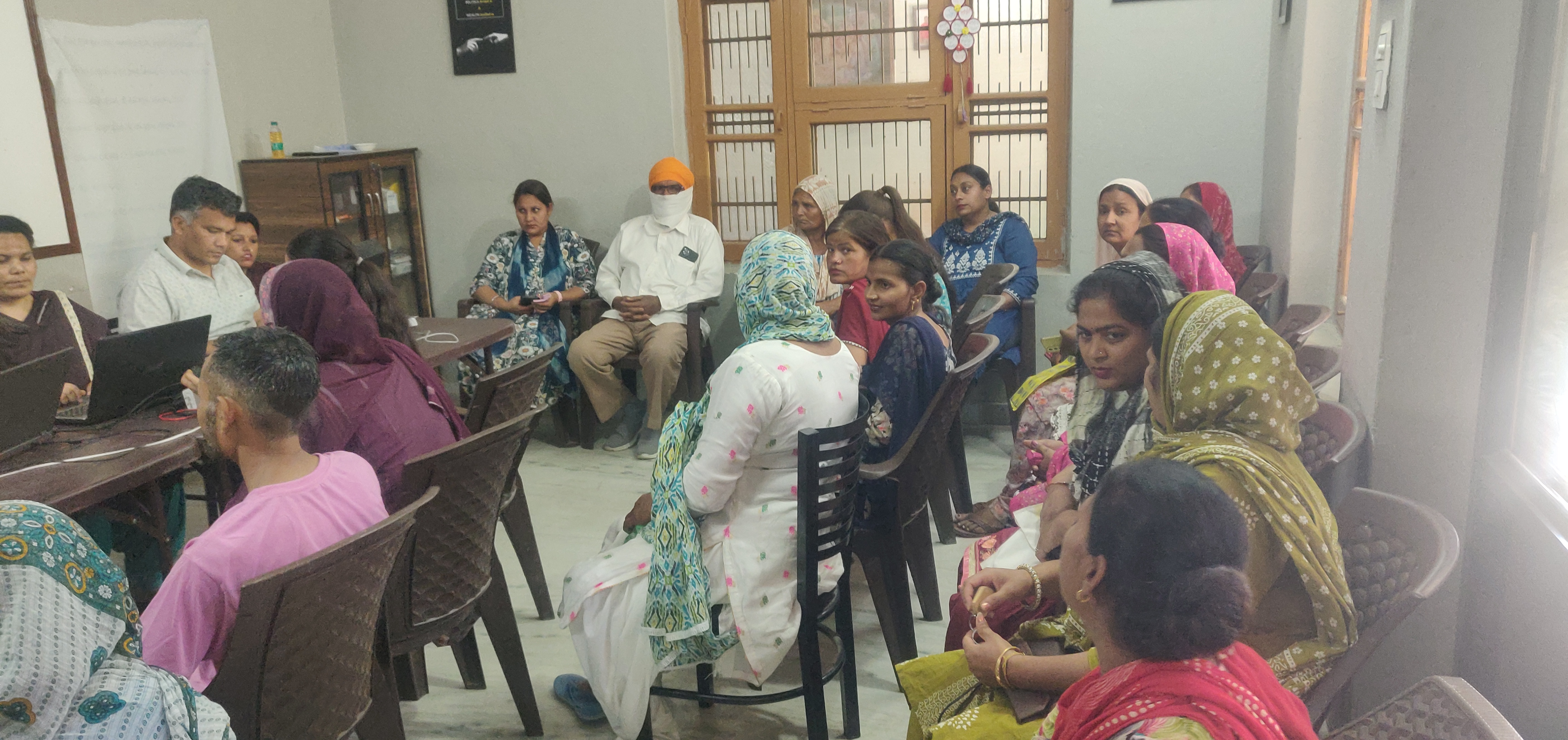 Community gathering in a rural Punjab village, evening light
